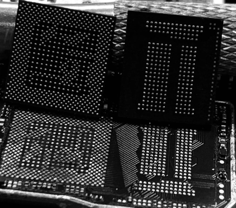 Close-up of memory and processor chips removed from a board, showing every solder ball intact