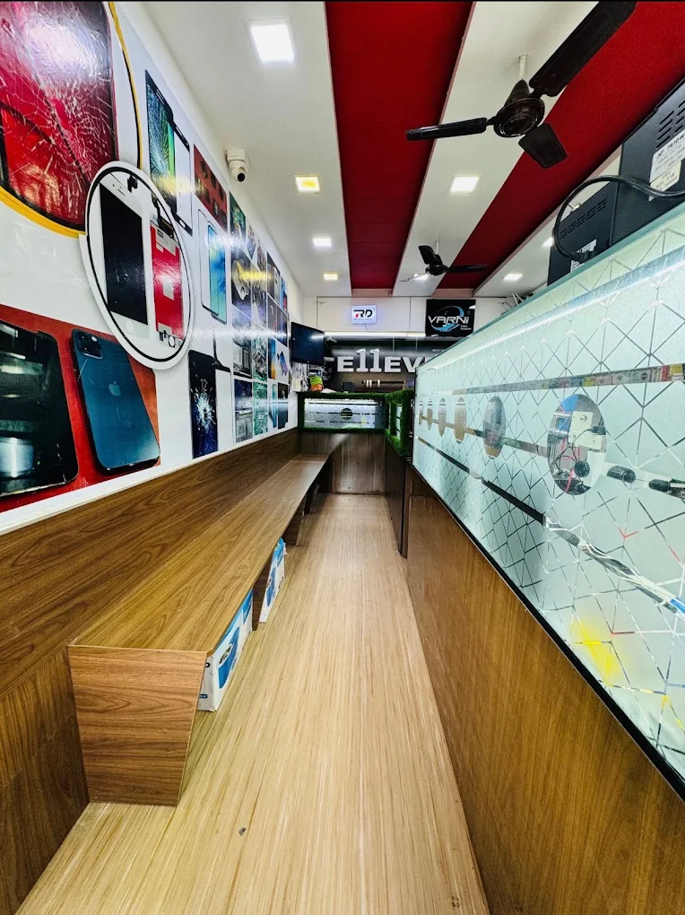 Shop aisle lined with posters of damaged screens and repairable devices next to the glass display counter