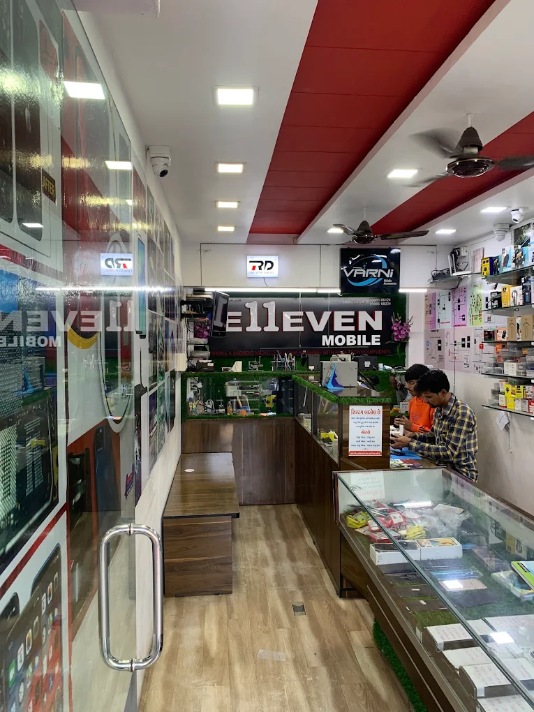 Entrance of E11EVEN MOBILE showing the accessory wall and staff serving customers at the counter